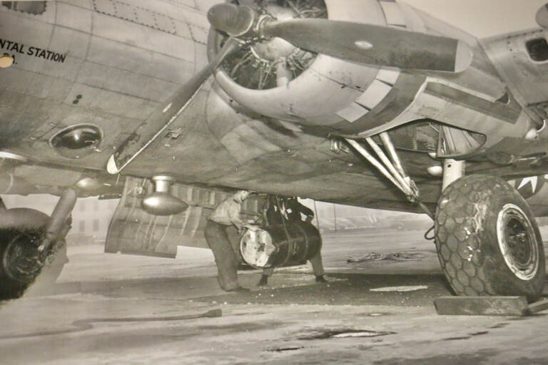 In a photo from the Papers of J. Hartley Bowen Jr. at the Science History Museum, workers load a barrel of contaminated waste into a B-17 aircraft. (The Papers of J. Hartley Bowen Jr. at the Science History Museum)
