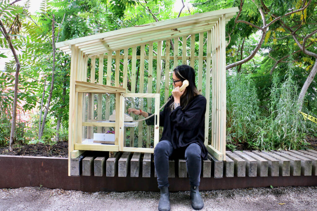 2023 06 23-e lee-annie chiu mccabe-philadelphia rail park-the thread installation phone dial Annie Chiu-McCabe dials a rotary phone inside a wooden structure at the Rail Park.