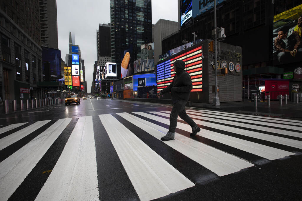 The Lonely Nation FILE - A man crosses the street in a nearly empty Times Square, devoid of the usual weekday morning crowds, March 23, 2020, in New York. In May 2023, U.S. Surgeon General Vivek Murthy declared loneliness an American epidemic. While solitude and isolation do not automatically equal loneliness, Murthy’s report found, people tightened their groups of friends and cut time spent with them during the pandemic. According to the report, Americans spent 20 minutes a day with friends in 2020 — down from an hour daily two decades ago. (AP Photo/Mark Lennihan, File)