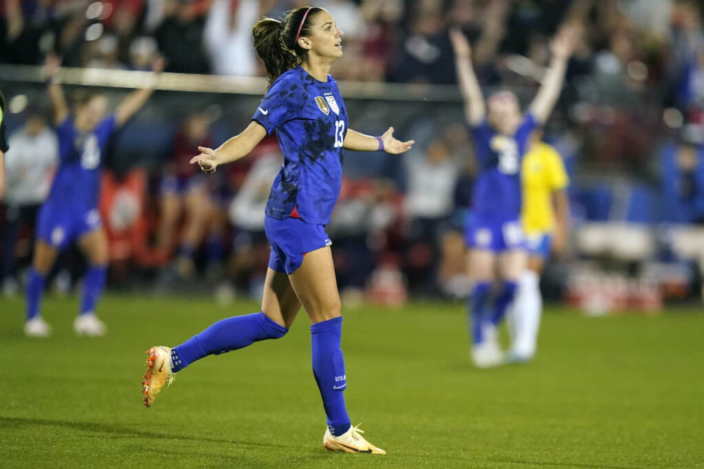 United States forward Alex Morgan (13) reacts to scoring a goal during the first half of a SheBelieves Cup soccer match against Brazil Wednesday, Feb. 22, 2023, in Frisco, Texas