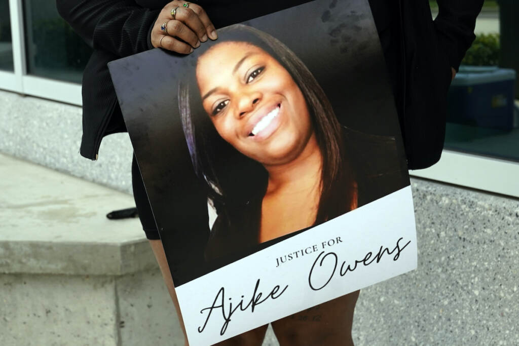 Neighbor Shooting Florida A protester, holds a poster of Ajike Owens at the Marion County Courthouse, Tuesday, June 6, 2023, in Ocala, demanding the arrest of a woman who shot and killed Owens, a 35-year-old mother of four, last Friday night, June 2. Authorities came under intense pressure Tuesday to bring charges against a white woman who killed Owens, a Black neighbor, on her front doorstep, as they navigated Florida’s divisive stand your ground law that provides considerable leeway to the suspect in making a claim of self defense