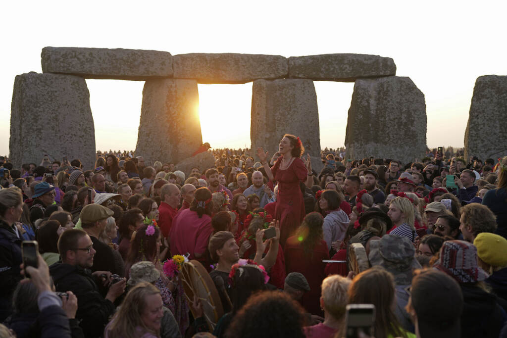 Revelers gather at the ancient stone circle Stonehenge to celebrate the Summer Solstice, the longest day of the year, near Salisbury, England, Wednesday, June 21, 2023. Druids, pagans, hippies, local residents, tourists and costumed witches and wizards have gathered around a prehistoric stone circle on a plain in southern England to express their devotion to the sun