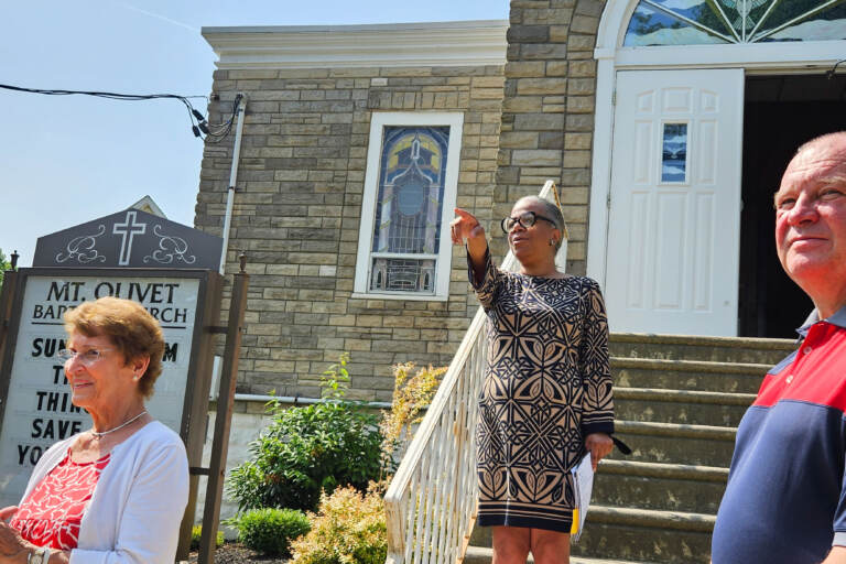 C. Adrienne Rhodes, co-founder of the Preserving Black Haddonfield History Project, stands on the steps of Mount Olivet Baptist Church and Parsonage in Haddonfield, N.J., on June 19, 2023. (Nicole Leonard/WHYY)