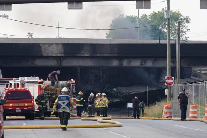 First responders work to extinguish a vehicle fire, Sunday June 11, 2023, that caused an overpass on I-95 to collapse near the Cottman Avenue exit