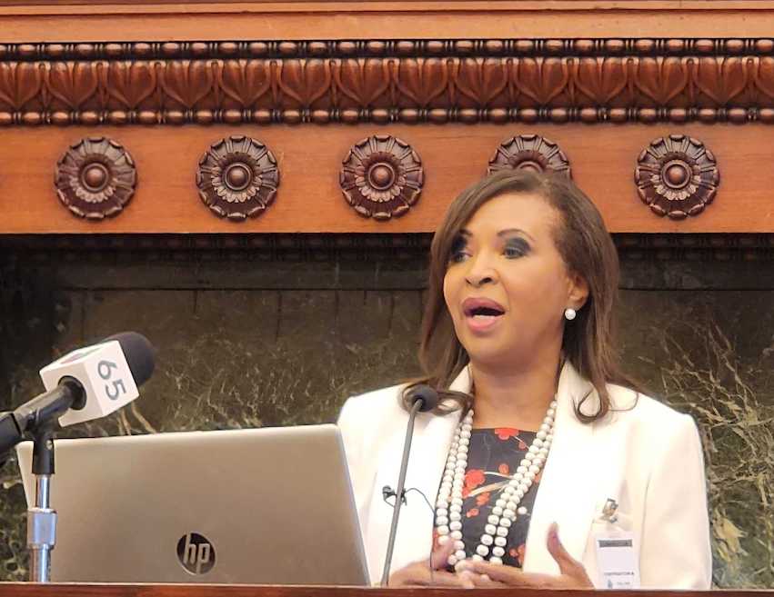Patricia Sanford speaks at a podium.