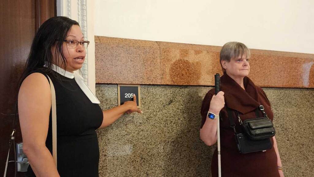 ada-upgrades-philadelphia-2 Adrienne Ewing and Susanne Erb stand beside a new ADA compliant sign in Philadelphia City Hall.