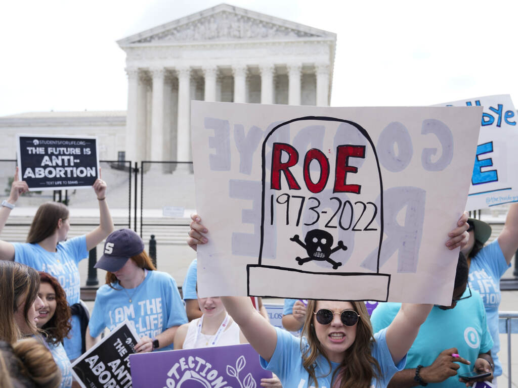 Demonstrators protest about abortion outside the Supreme Court in Washington, June 24, 2022. In the year since, approximately 22 million women, girls and other people of reproductive age now live in states where abortion access is heavily restricted or totally inaccessible. A person holds up a protest sign outside the U.S. Supreme Court.