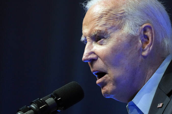 An up-close view of Joe Biden speaking into a microphone.