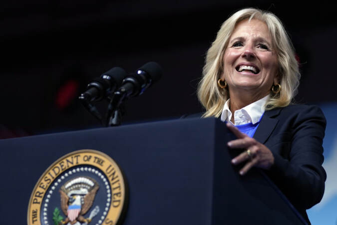 First Lady Jill Biden stands at a podium.