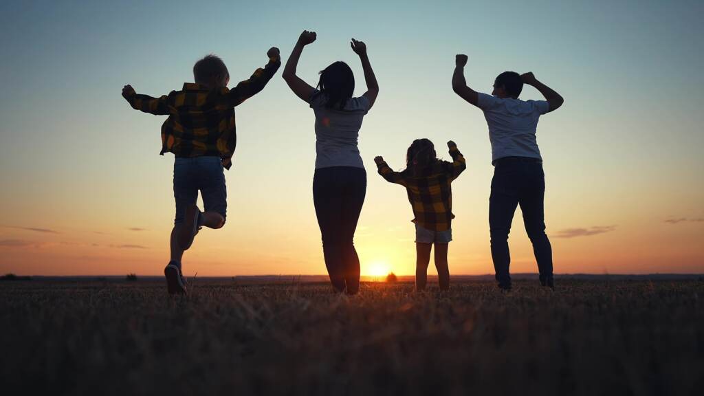 Friendly Family Jumping Rejoice. Silhouette A Happy Family Bounc