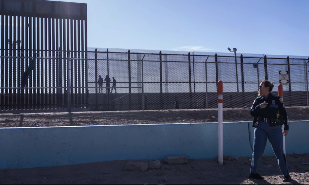 An officer at the border wall.