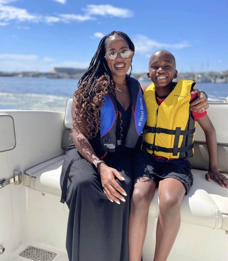 Tomika and Solomon Anderson posing on a boat.