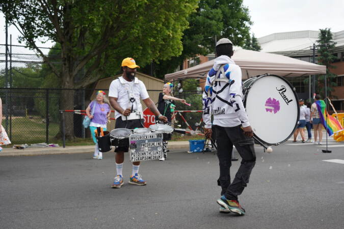 Drummers walk together in the street during Delco's Pride Parade.