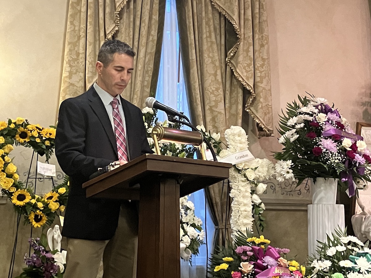 Anthony Allegrini Sr. speaks at a podium.