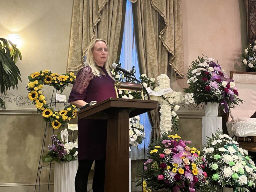 Jennifer Allegrini speaks at a podium.