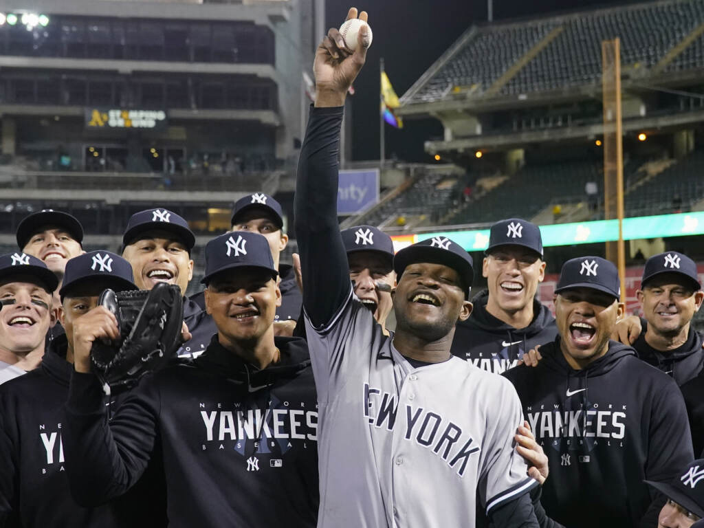 New York Yankees pitcher Domingo Germán, center, poses for a photograph with the team after his perfect game against the Oakland Athletics during a baseball game in Oakland, Calif., Wednesday, June 28, 2023. New York Yankees pitcher Domingo Germán, center, poses for a photograph with the team after his perfect game against the Oakland Athletics during a baseball game in Oakland, Calif., Wednesday, June 28, 2023.