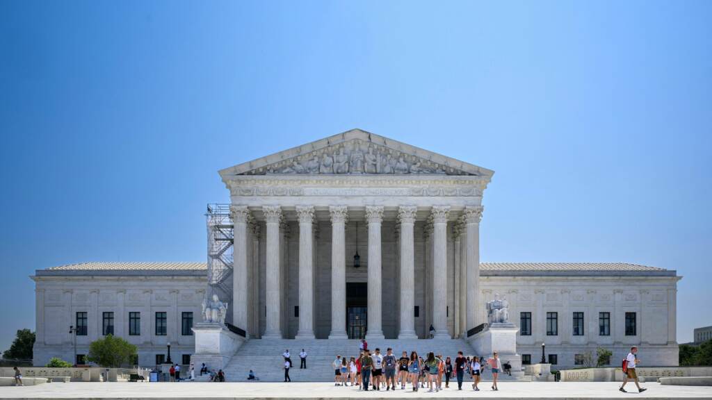 The U.S. Supreme Court building is visible on a sunny day.