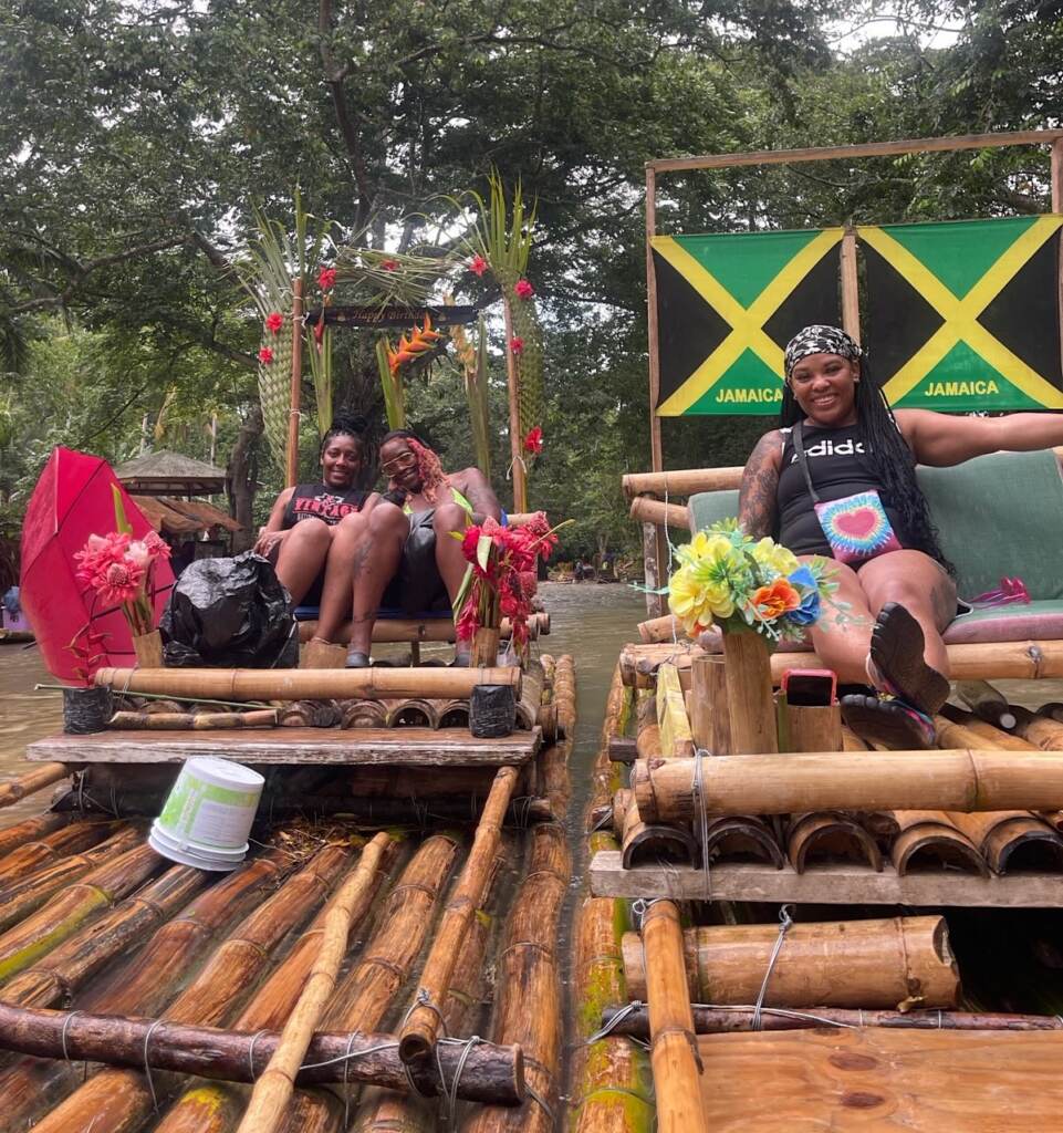 Three women relaxing on bamboo rafts.