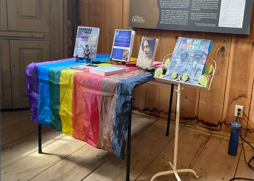 lgbtq-presentation-photo-c-ransom-2023-06-22 Books displayed on a table with a Pride flag