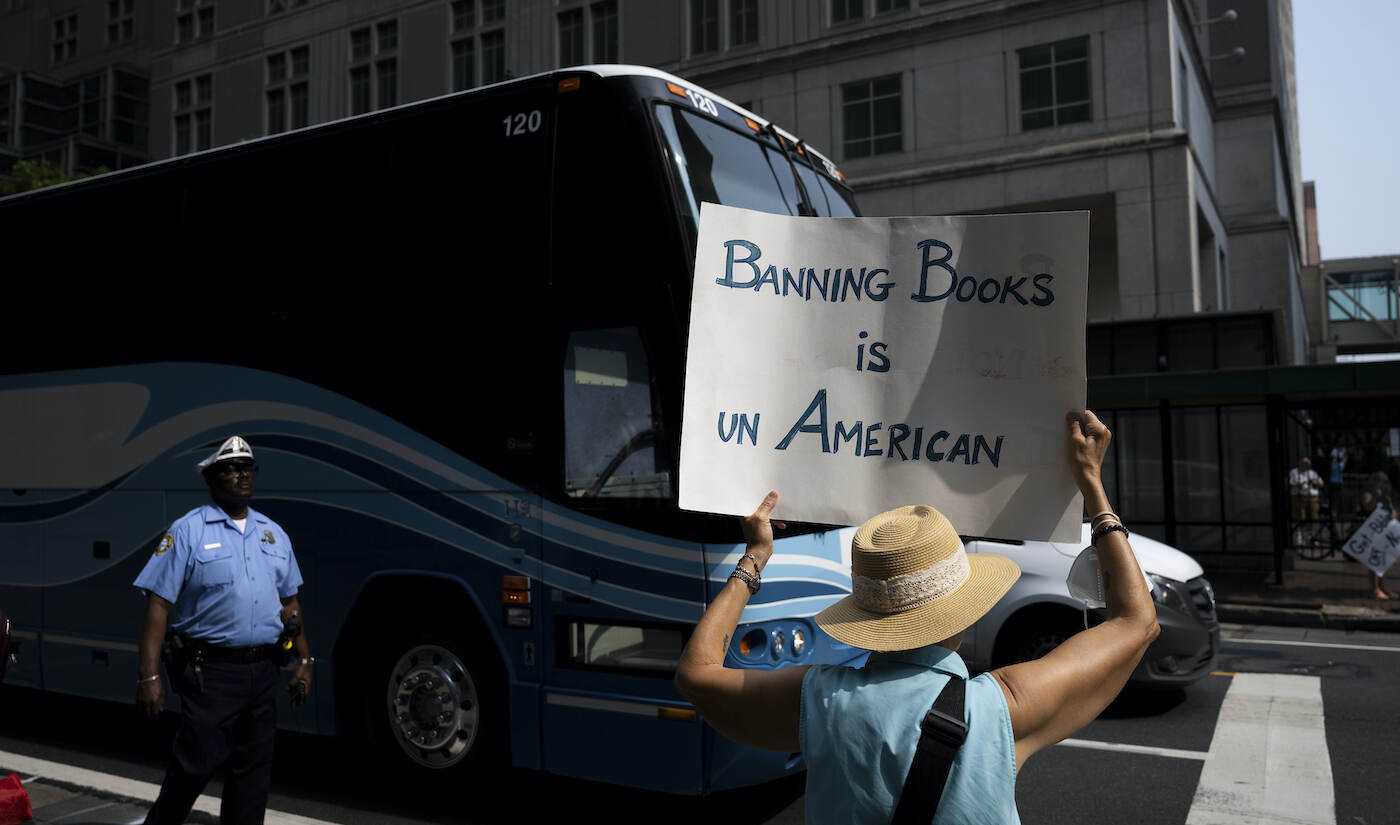 Protester on the street holding a sign that says 'Banning Books is UnAmerican'