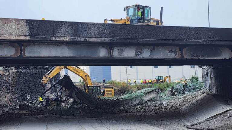 Crews work on I-95, where a section of highway collapsed from a tanker fire.
