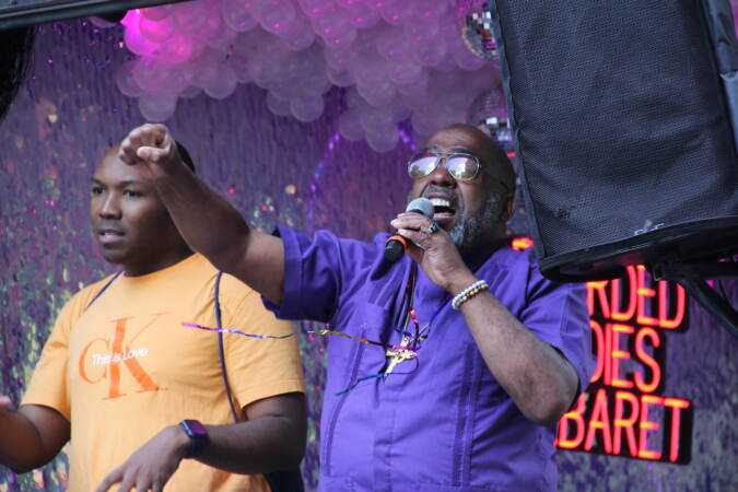 Rev. Jeffrey Jordan speaking into a microphone on stage.
