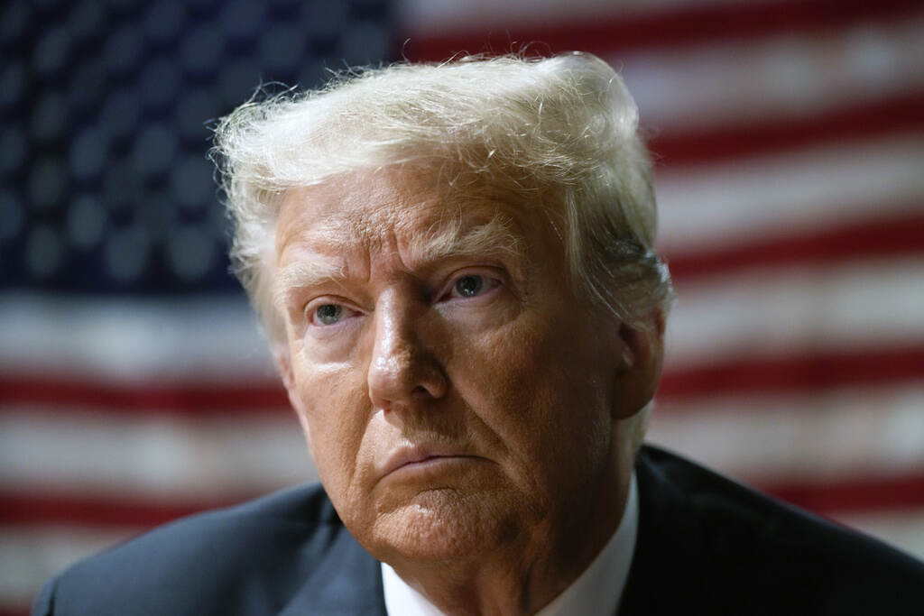 Trump Classified Documents Trump is visible in front of a U.S. flag.