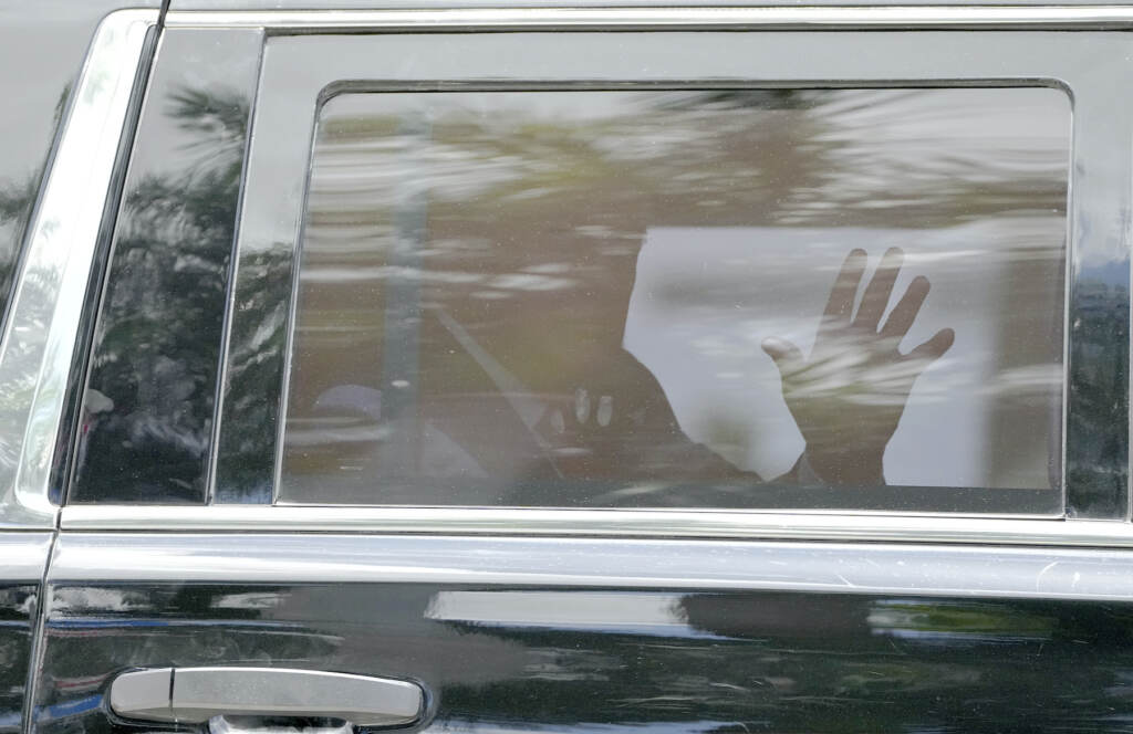 Trump waves from the car