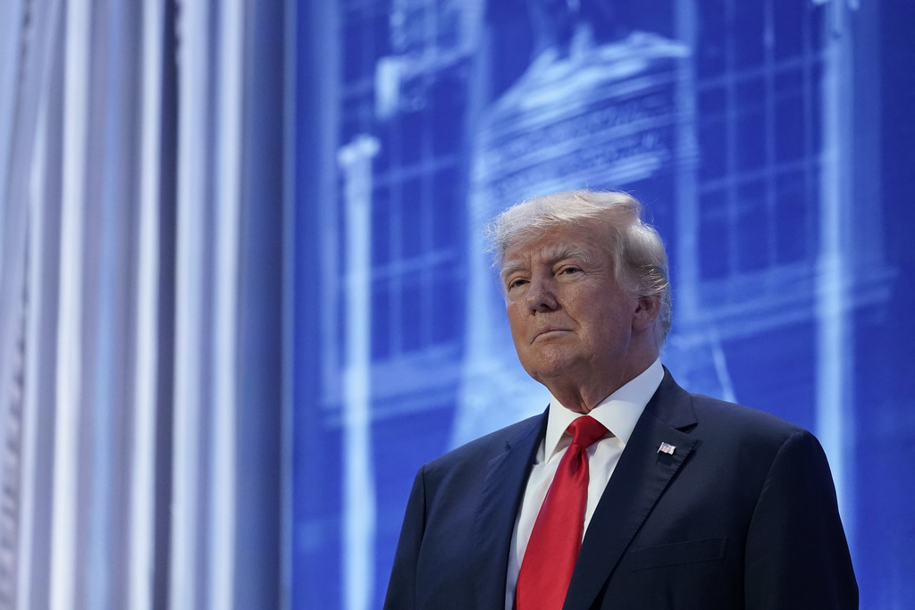 Trump stands onstage.