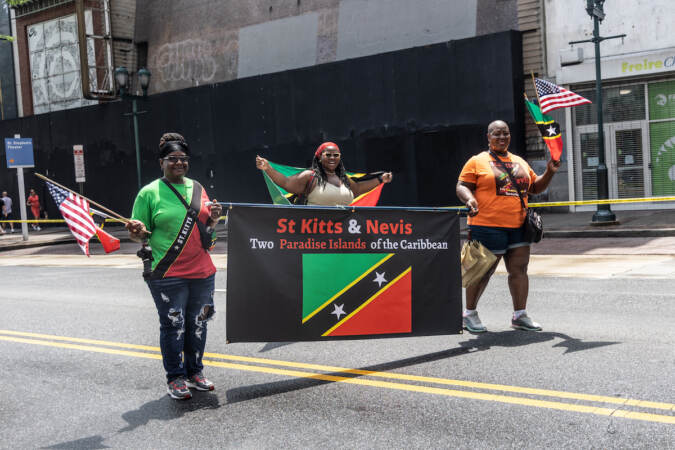 People carrying a sign that reads 