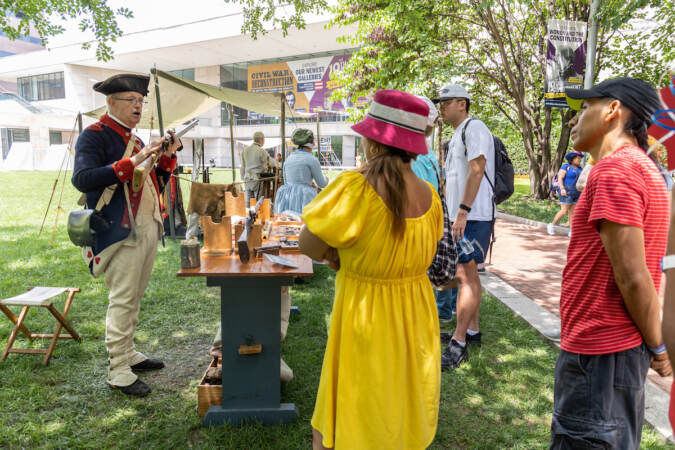 A Revolutionary War actor talks to a crowd.