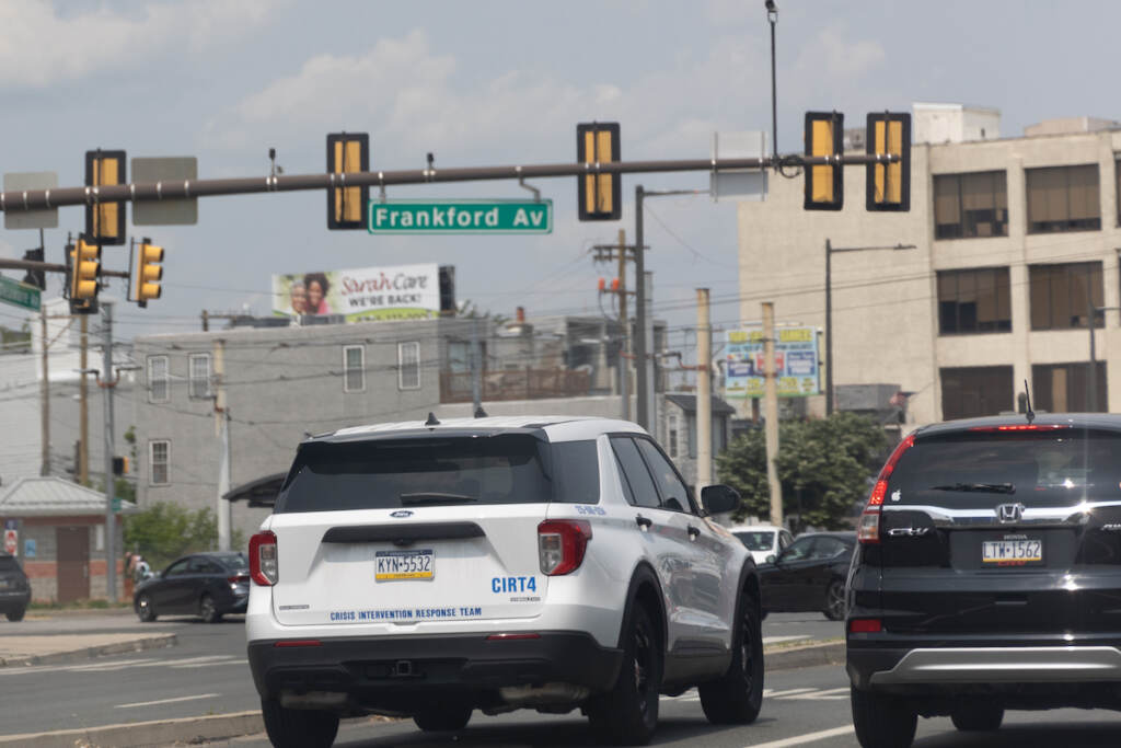 A police vehicle labeled as a CIRT vehicle drives down the road.