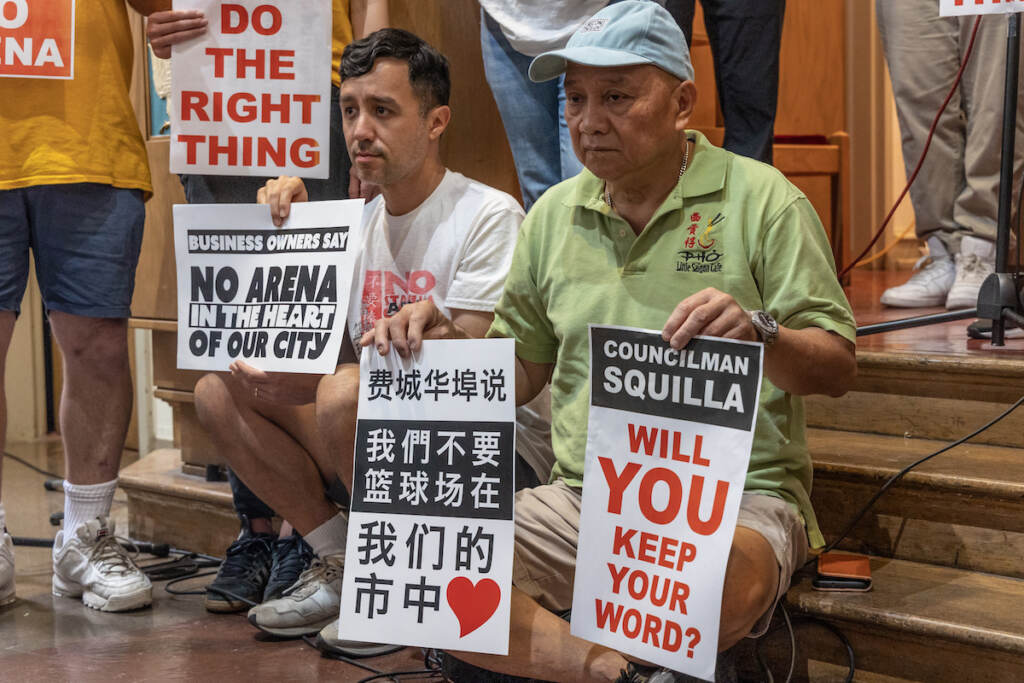 07 21 2023 k paynter arena proposal in chinatown 1 year presser People hold signs that read Councilmember Squilla will you keep your word? Another person holds a sign written in Chinese.