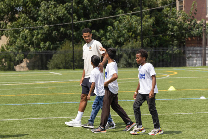 Professional Chelsea football player Levi Colwell give soccer tips to Philadelphia kids at the Chelsea Foundation’s Football Festival at Cristo Rey High School on July 24, 2023