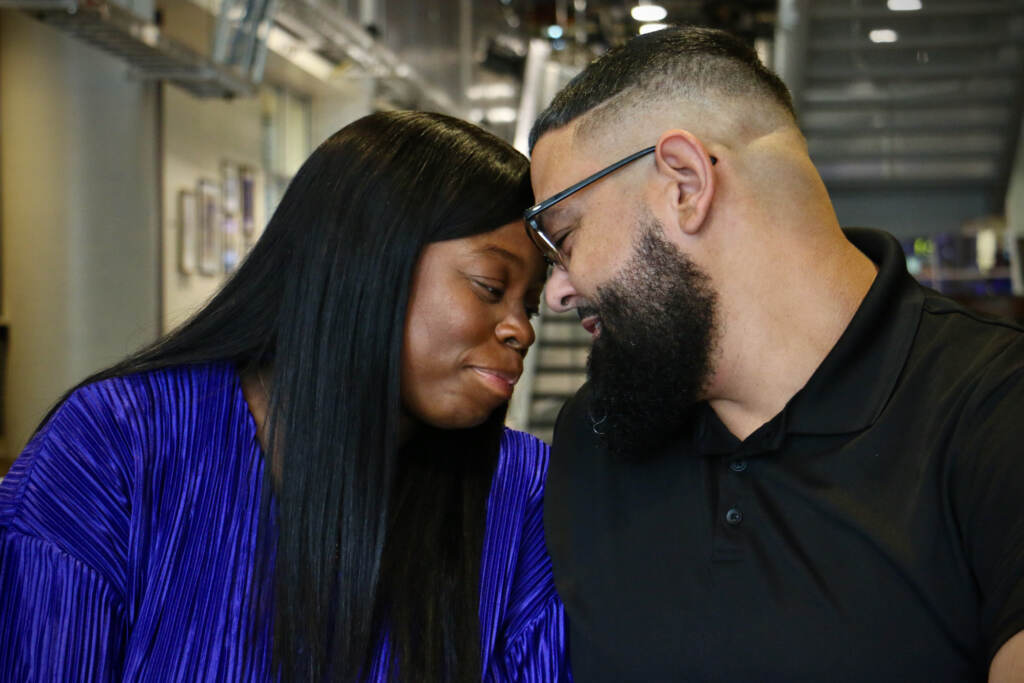 Rasheida and Raymond Colon pose with their heads together.