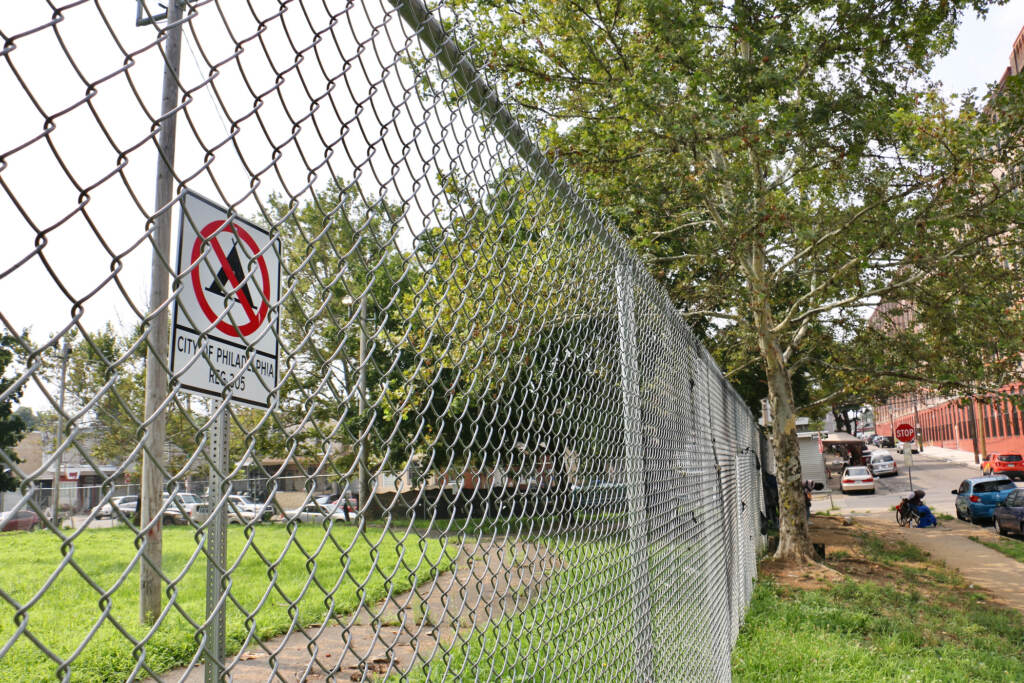 A view of the park through a fence.