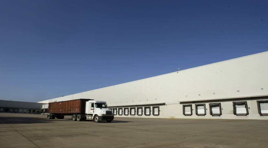 Dillards Distribution Center A truck drives past loading docks at a distribution center
