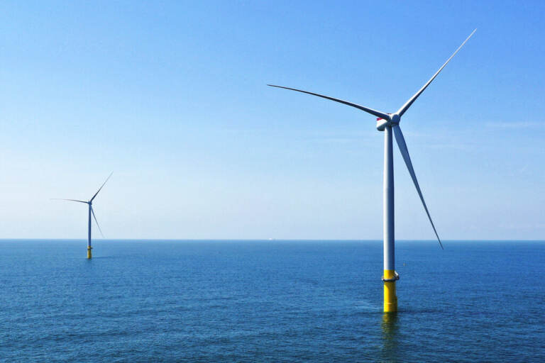 FILE - Two of the offshore wind turbines, which have been constructed off the coast of Virginia Beach, Va., are seen, June 29, 2020. (AP Photo/Steve Helber, File)