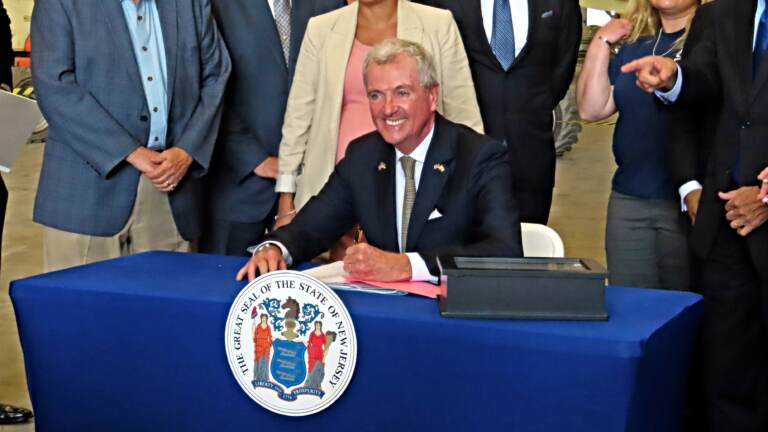 New Jersey Gov. Phil Murphy signs a bill in Paulsboro, N.J., Thursday, July 6, 2023, granting a tax break to offshore wind energy developer Orsted