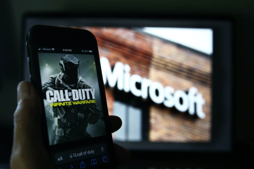 Microsoft Activision Blizzard File photo: An image from Activision's Call of Duty is shown on a smartphone near a photograph of the Microsoft logo in this photo taken in New York, Thursday, June 15, 2023.