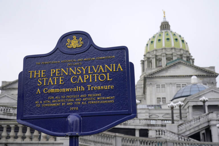 An historical marker at the Pennsylvania Capitol in Harrisburg, Pa., is seen on Feb. 21, 2023. A partisan dispute about funding for three of Pennsylvania’s state-related universities may mean higher tuition for in-state students as a budget impasse continues further into the summer. The state government approached two weeks without full spending authority on Tuesday, July 11, while loose ends remained untied. (AP Photo/Matt Rourke, File)
