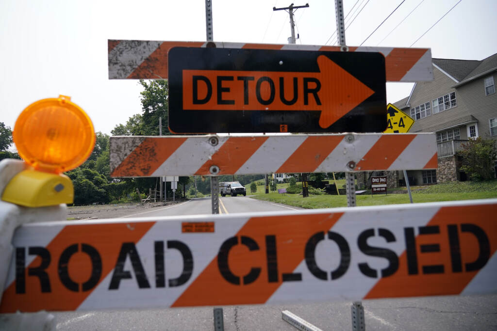 A roadblock is seen as crews search for a a pair of missing children swept away after weekend rains, Monday, July 17, 2023, in Washington Crossing, in Upper Makefield Township, Pa.
