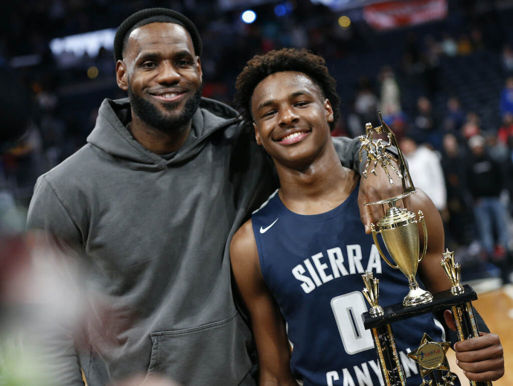 Bronny James Cardiac Arrest Basketball LeBron James (left) poses with his son Bronny after Sierra Canyon beat Akron St. Vincent - St. Mary in a high school basketball game, Saturday, Dec. 14, 2019, in Columbus, Ohio.