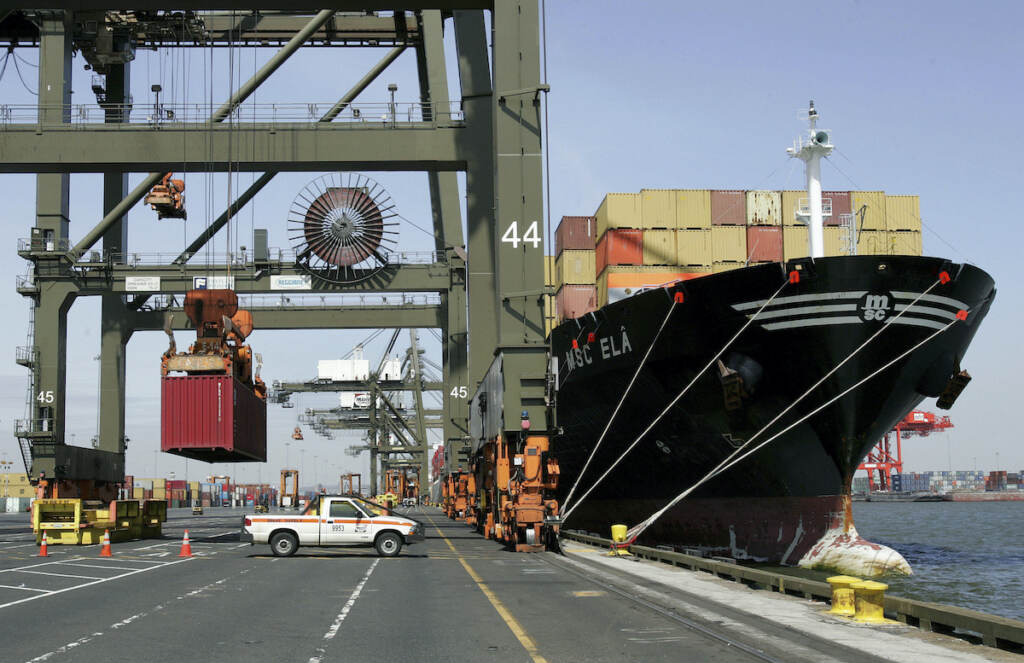 Port Strike NY NJ This Friday, April 21, 2006 file photo shows cargo containers stacked on the deck of a ship as a crane lifts another container at Port Newark in Newark, N.J.