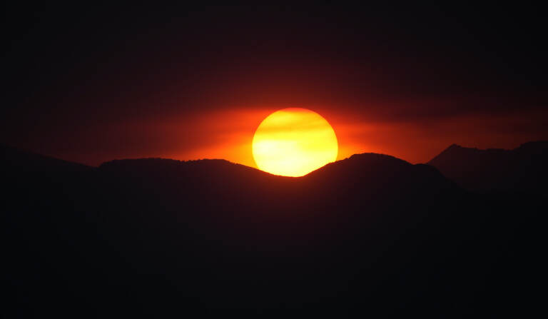The suns sets behind the Rocky Mountains
