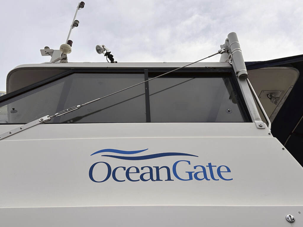 OceanGate says it’s pausing its commercial and exploration operations. Its CEO, Stockton Rush, was among the five people killed when the company’s Titan submersible imploded in June. Here, the OceanGate logo is seen on a boat parked near the company’s offices in Everett, Washington. A view of a boat with a sign that reads OceanGate.
