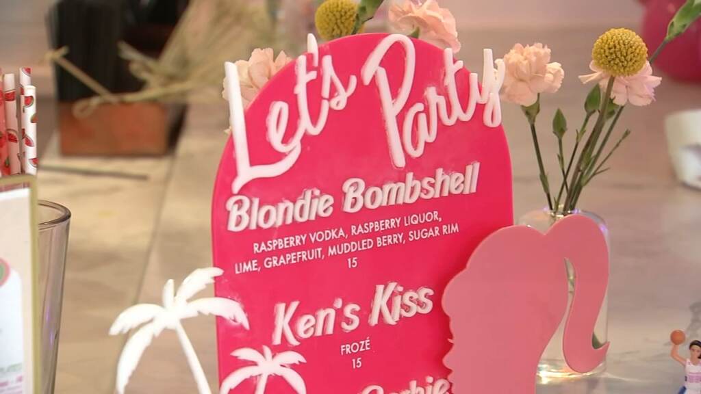 Sign saying 'Let's Party Barbie Bombshell'