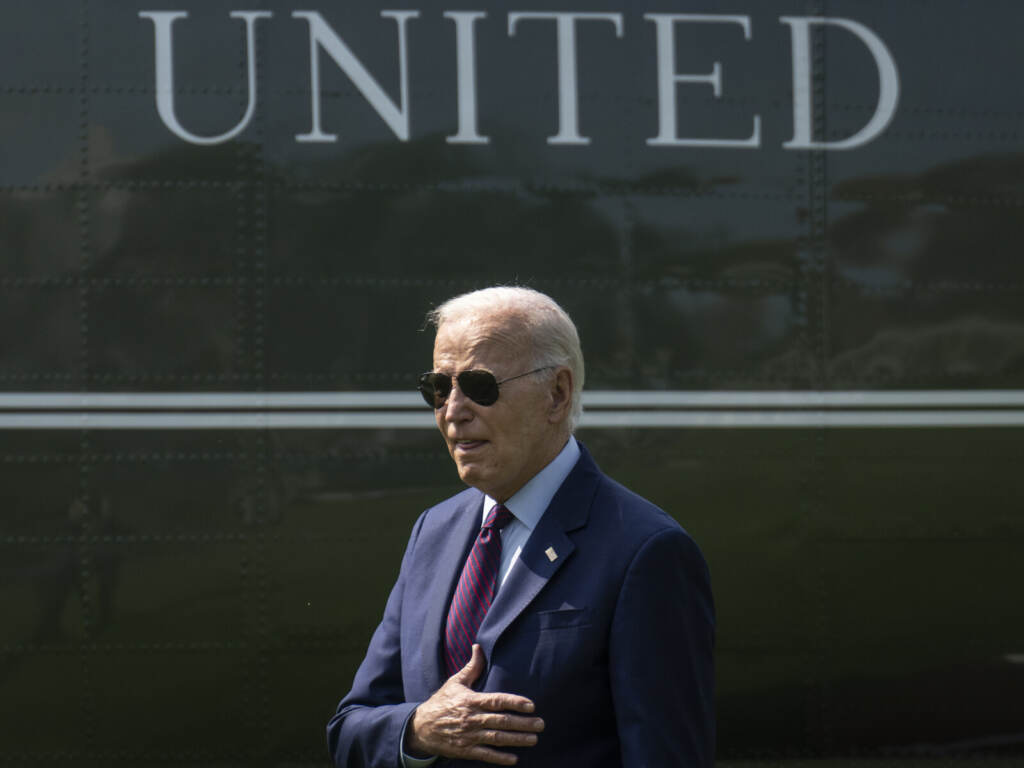President Biden Departs The White House En Route To Maine President Biden places his hand over his heart.