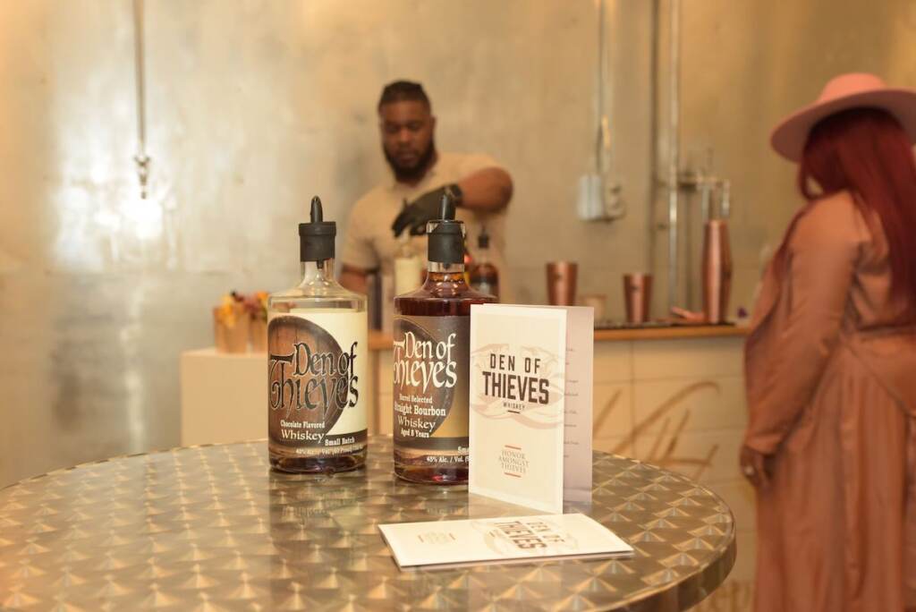 A close-up of spirits bottles with the label Den of Thieves.