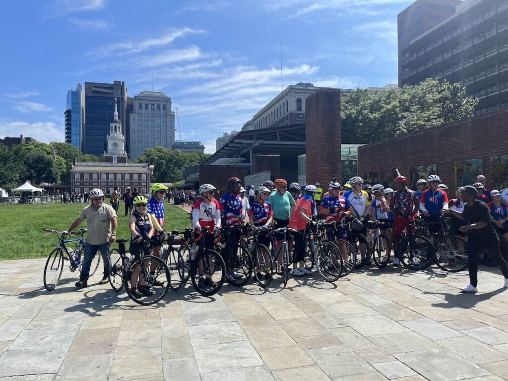 cyclists-911-memorial-trek-3 Cyclists pose for a photo in front of Independence Mall on a sunny day.